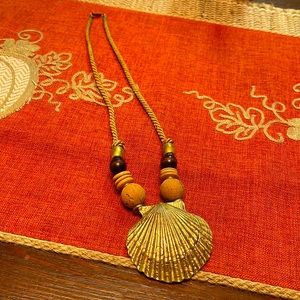 Vintage-Gold shell, cork, beaded rope necklace with a clasp.